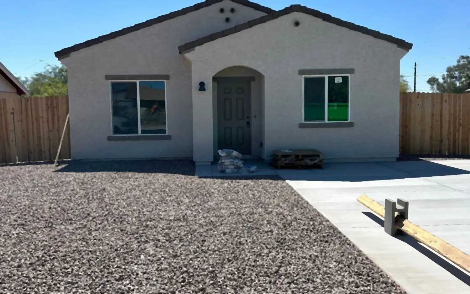 The same front yard after: decorative rock spread evenly to the sidewalk