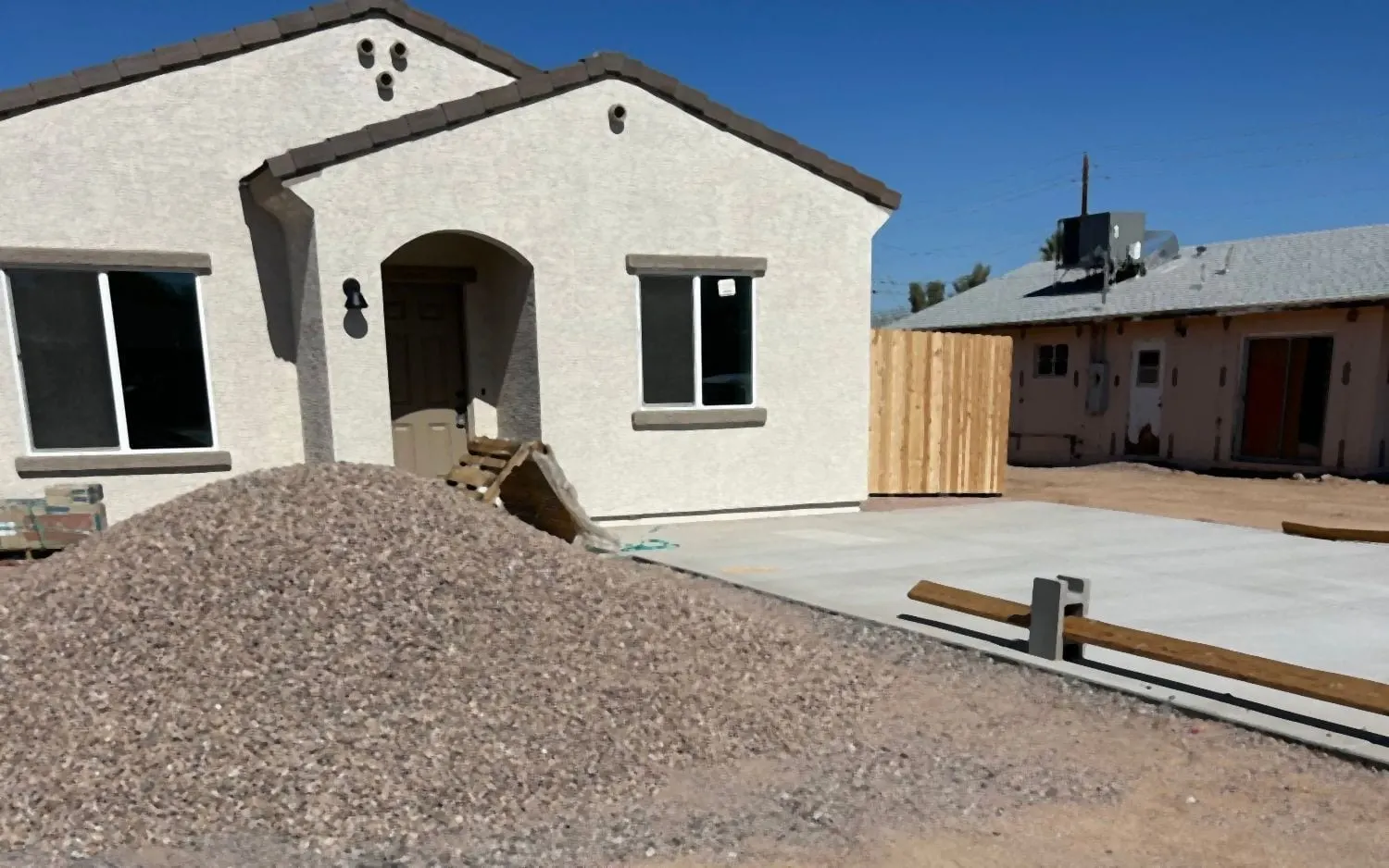 New-build front yard before: bare dirt and a pile of gravel