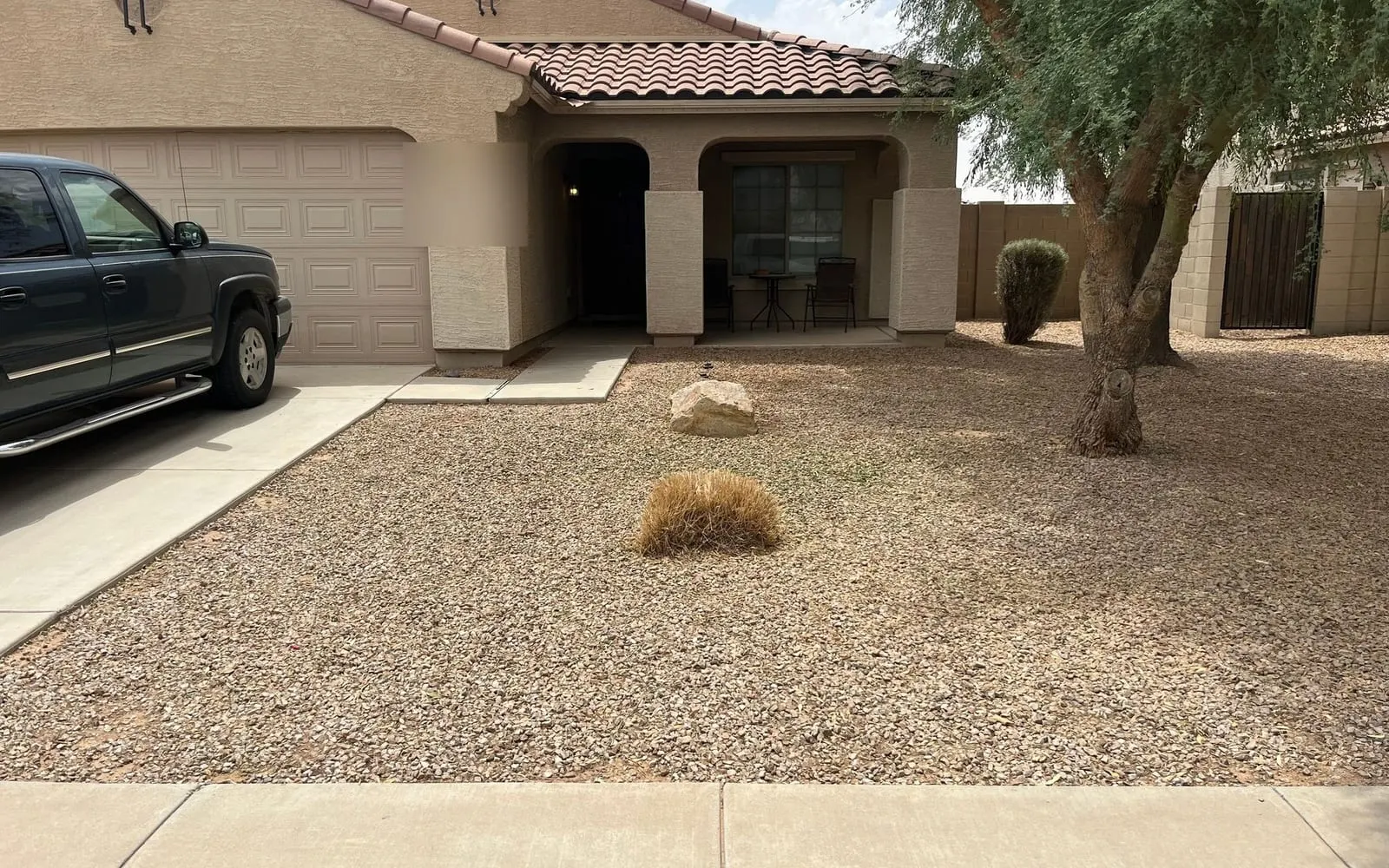 The same front yard after the branch was cut up and hauled away